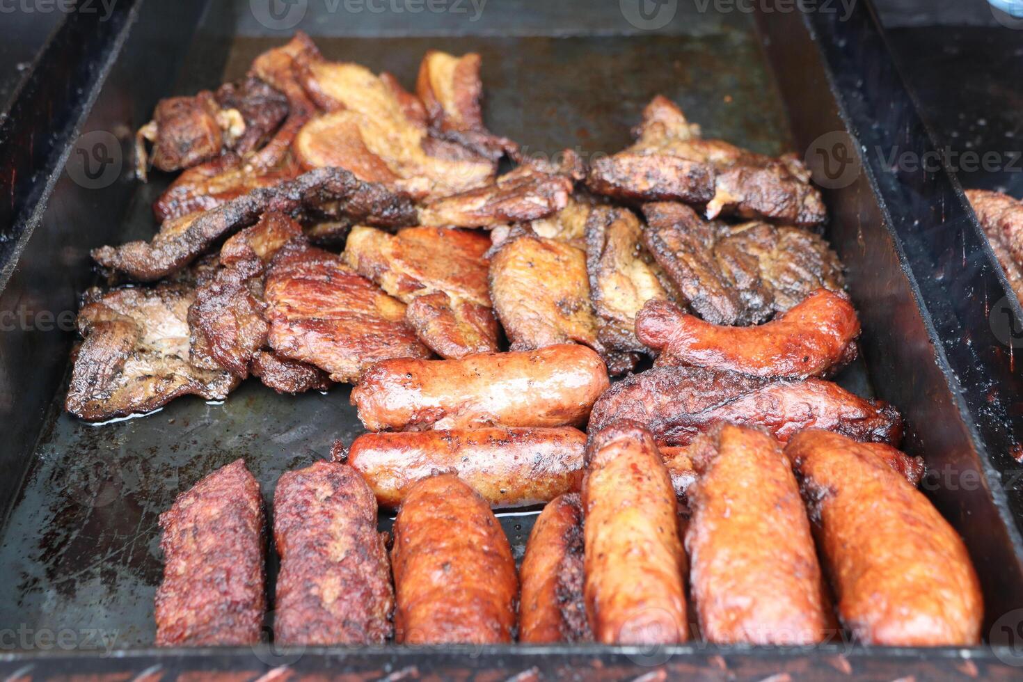 Enjoy the delicious flavors of expertly grilled meats and tasty sausages on a BBQ photo