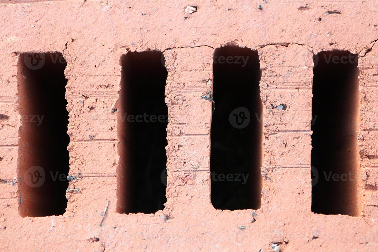 A Textured Brick Wall featuring Vertical Openings which creates an interesting visual effect photo