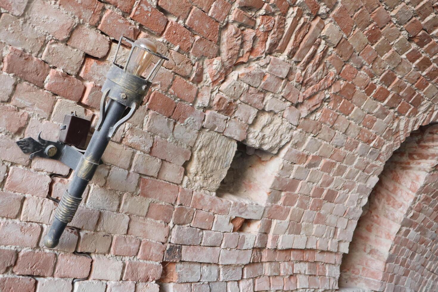 A historical brick wall that showcases unique features reflecting a rich and vibrant past photo