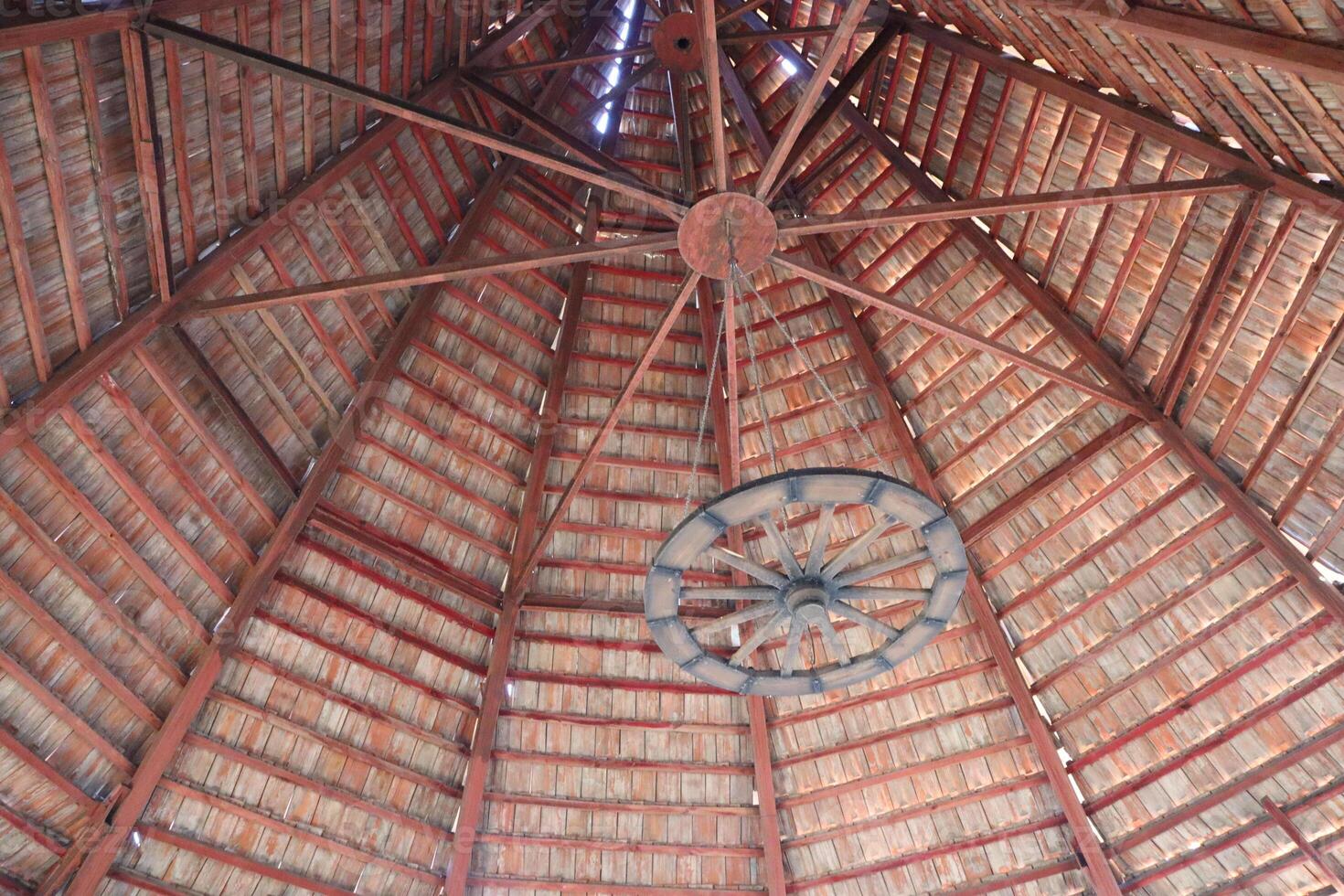 Rustic Wooden Structure Featuring a Unique Layered Roof Design That Exudes Warmth and Charm photo