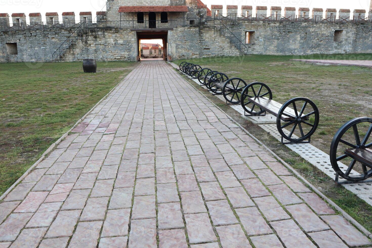 A Historic Pathway Adorned with Cannons Leading to the Grand Entrance of the Fortress photo