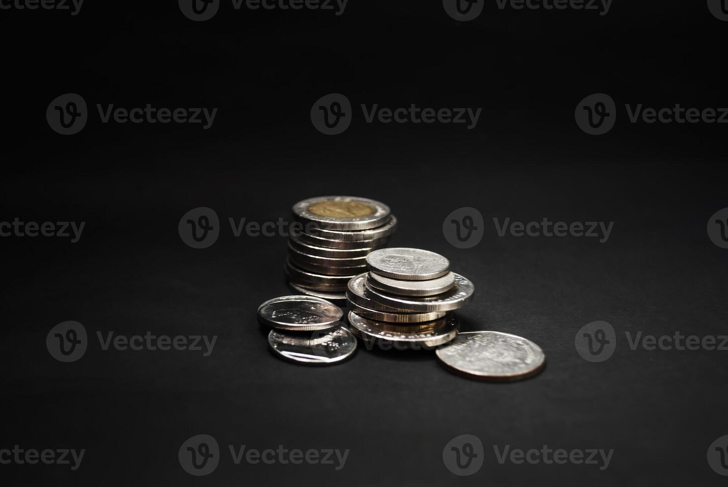 a stack of coins on a black background photo