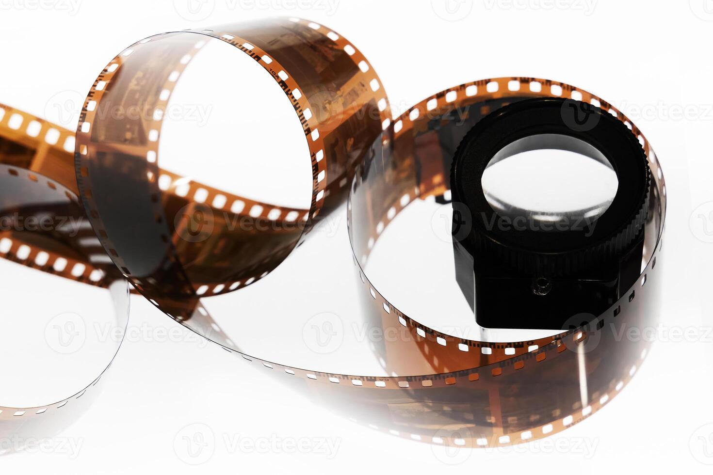 a roll of film is shown with a camera lens photo