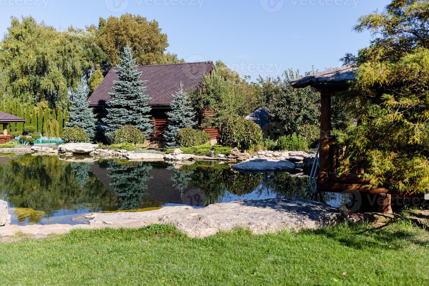 Beautiful wooden gazebo for outdoor recreation. Place in nature with a wooden house photo