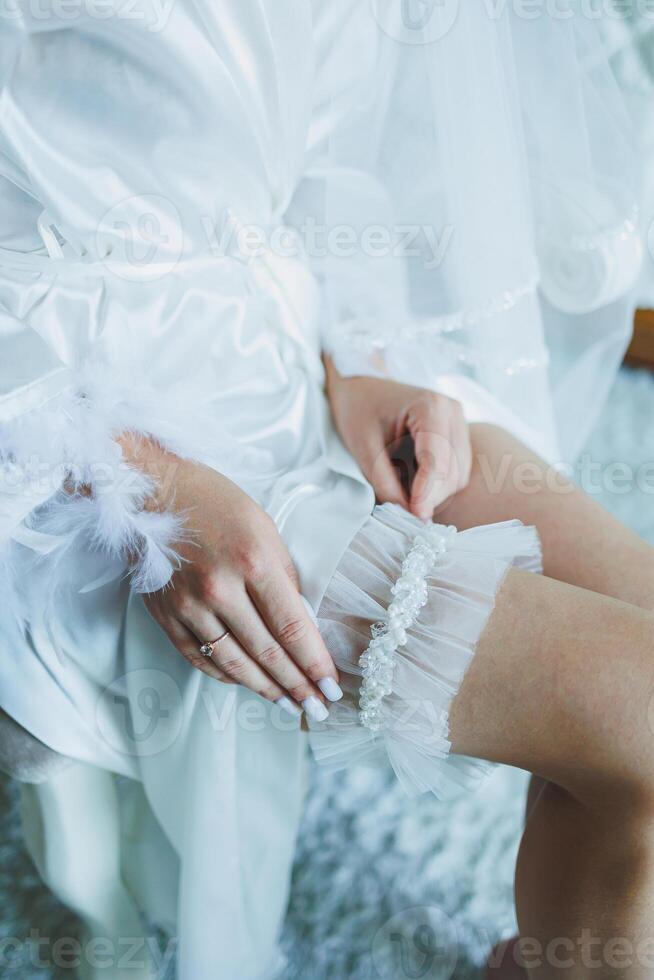 Garter on the bride's leg. Accessories for the bride. photo