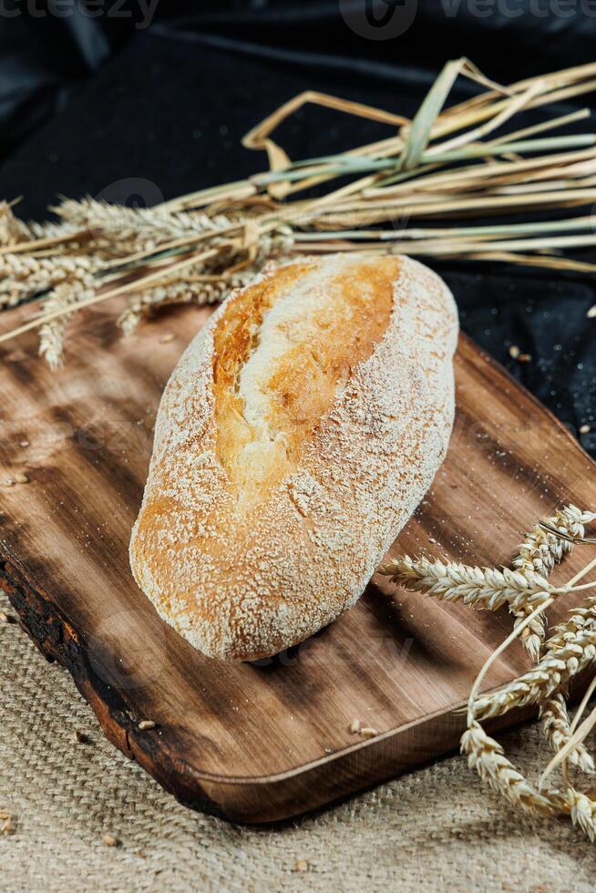 Freshly baked rye bread on yeast-free sourdough and whole grain, rye and wheat flour. It lies on a cut board. photo