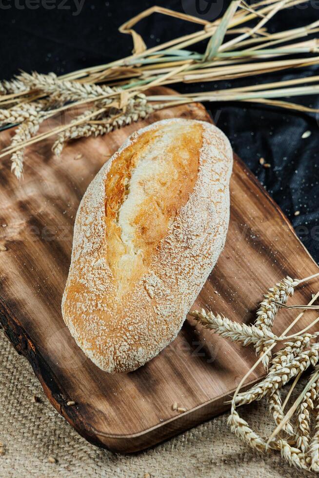 Freshly baked rye bread on yeast-free sourdough and whole grain, rye and wheat flour. It lies on a cut board. photo