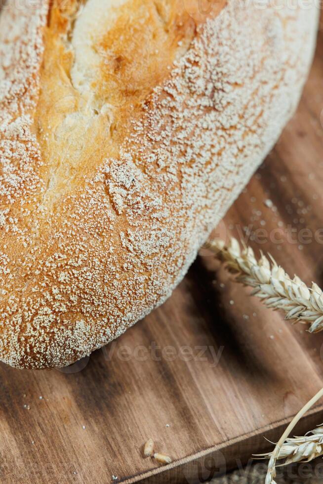 Freshly baked rye bread on yeast-free sourdough and whole grain, rye and wheat flour. It lies on a cut board. photo