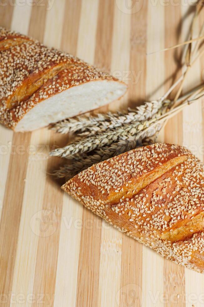 Freshly baked rye bread on yeast-free sourdough and whole grain, rye and wheat flour. It lies on a cut board. photo