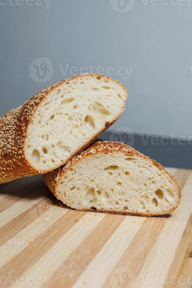 Freshly baked rye bread on yeast-free sourdough and whole grain, rye and wheat flour. It lies on a cut board. photo