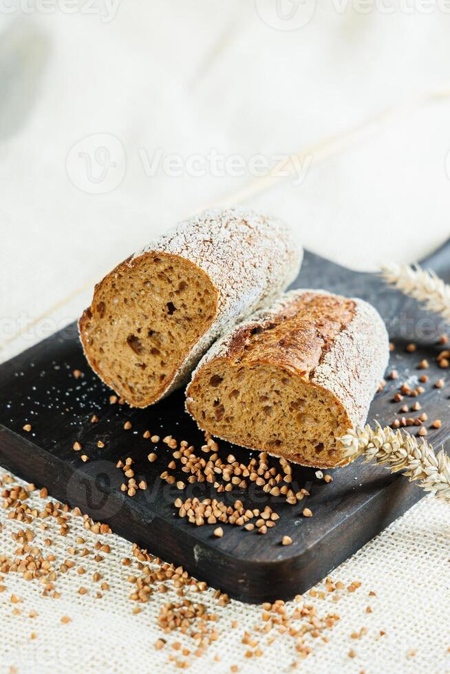 Freshly baked rye bread on a mixture of whole grain, rye and wheat flour. Fresh homemade bread. Craft pastries photo