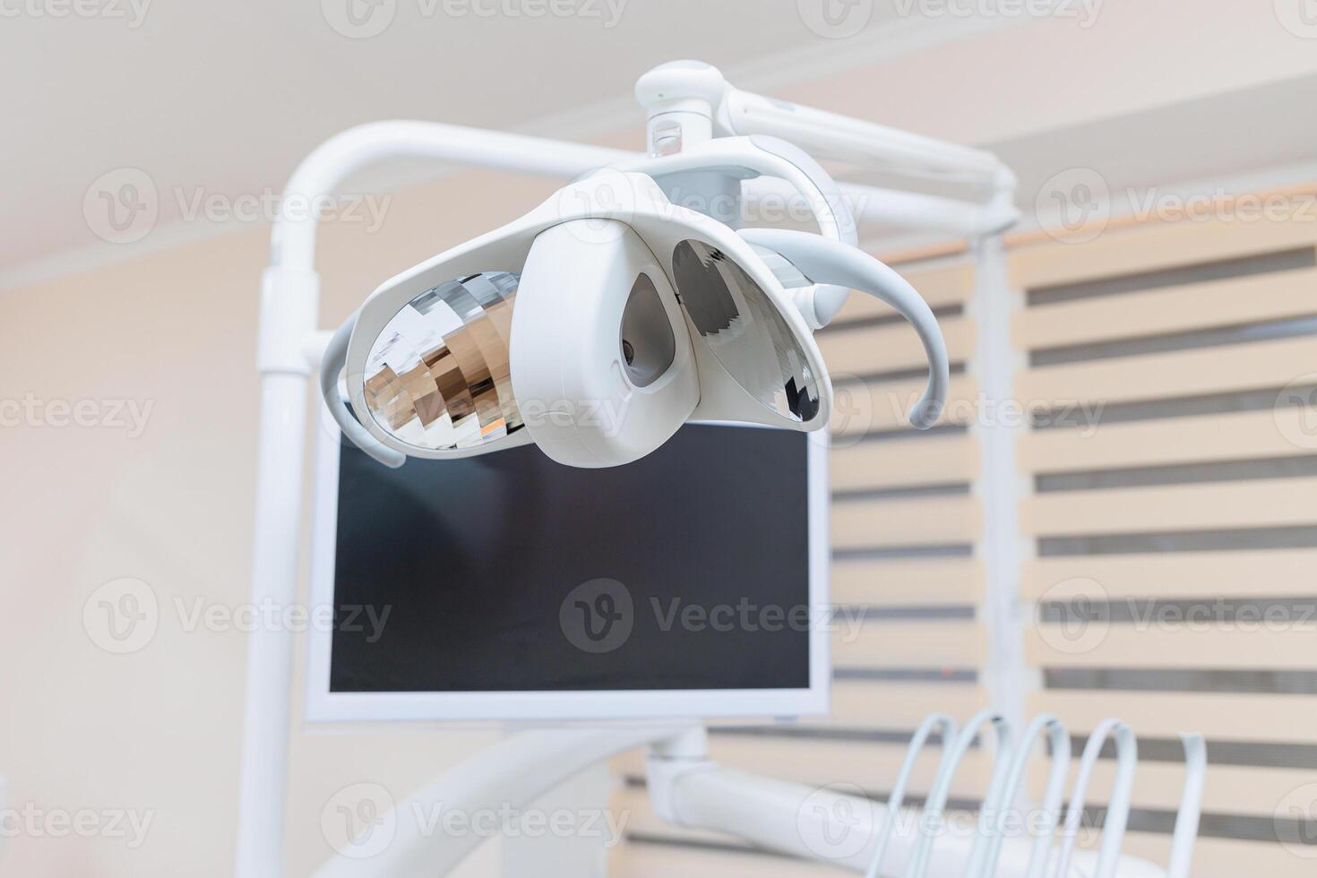 Modern dental clinic, dental chair and other accessories used by dentists in medical light. photo