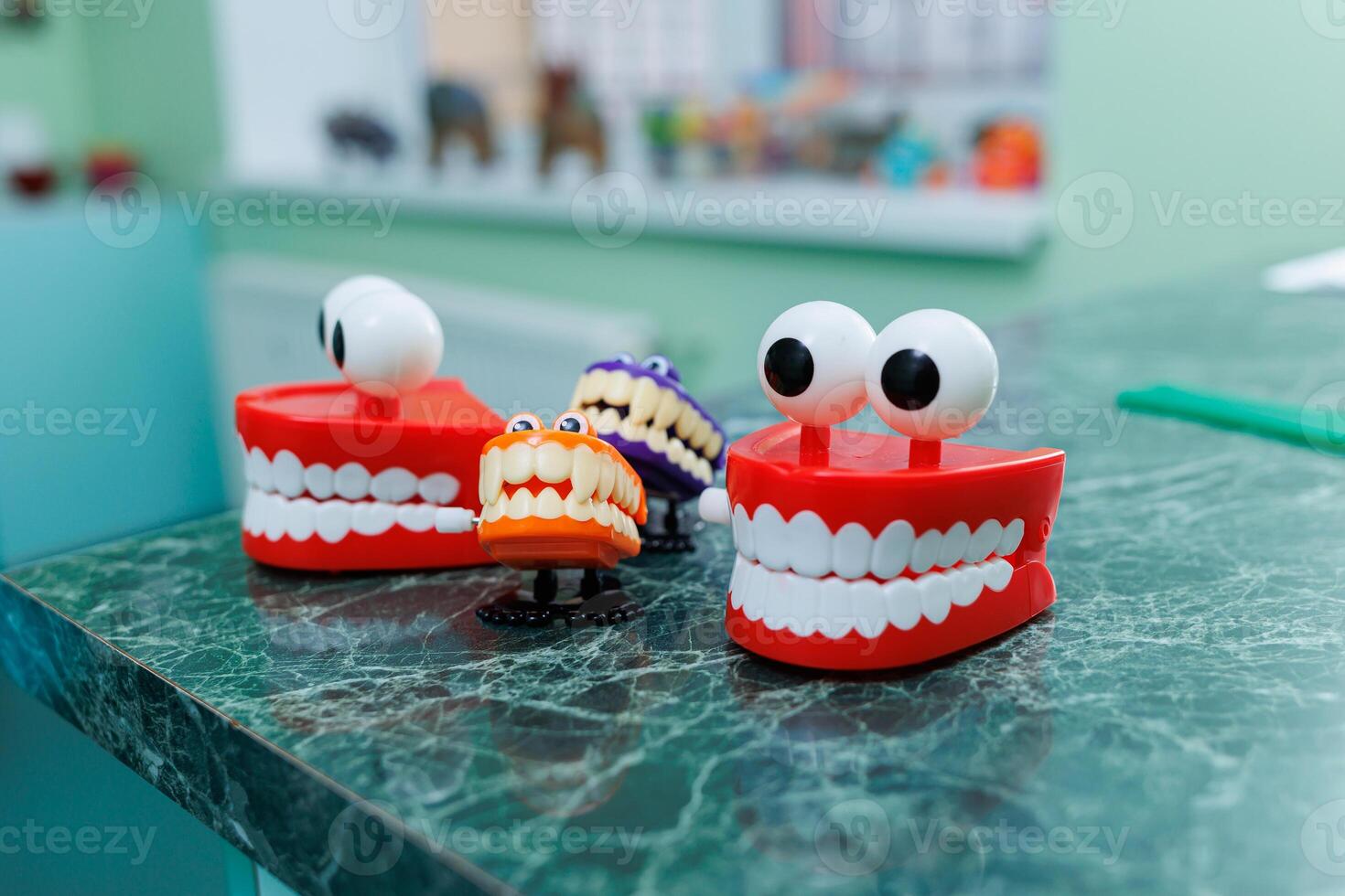 Miniatures of dental artificial jaws with eyes. A plastic model of teeth sits on a table in a dentist's office. photo