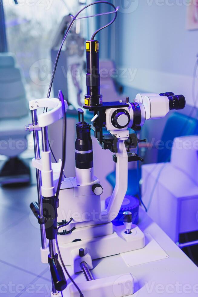 A modern microscope for vision testing in a light room. Microscope for vision correction. photo