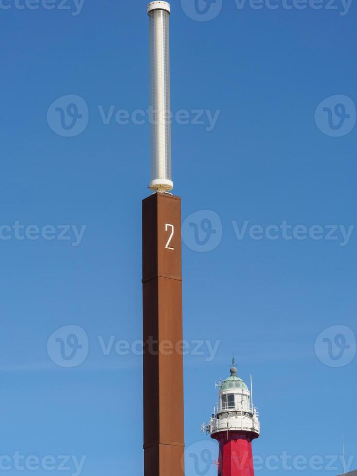 A tall pole with a clock on it photo