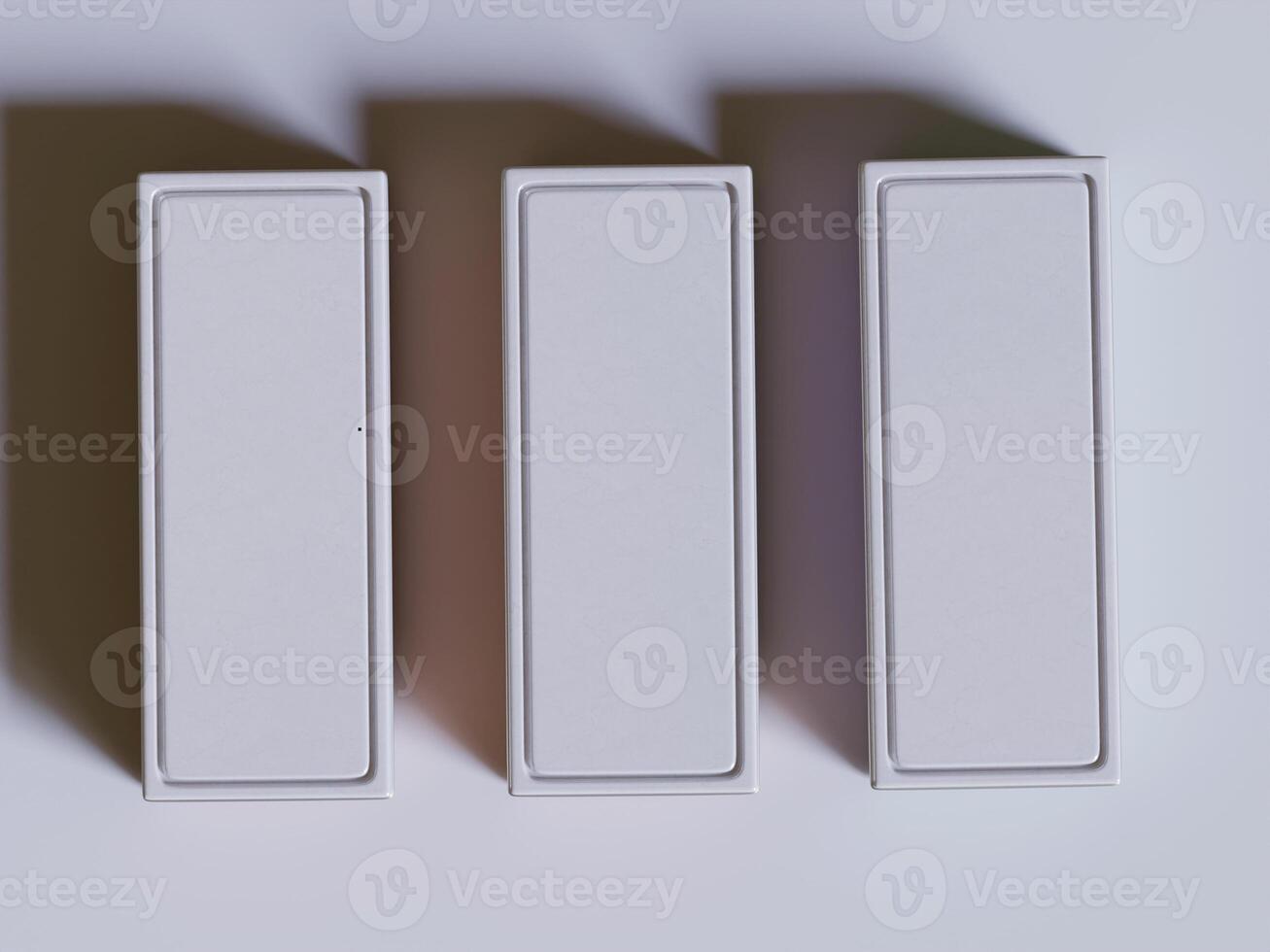 Three white boxes with shadows on a white surface photo