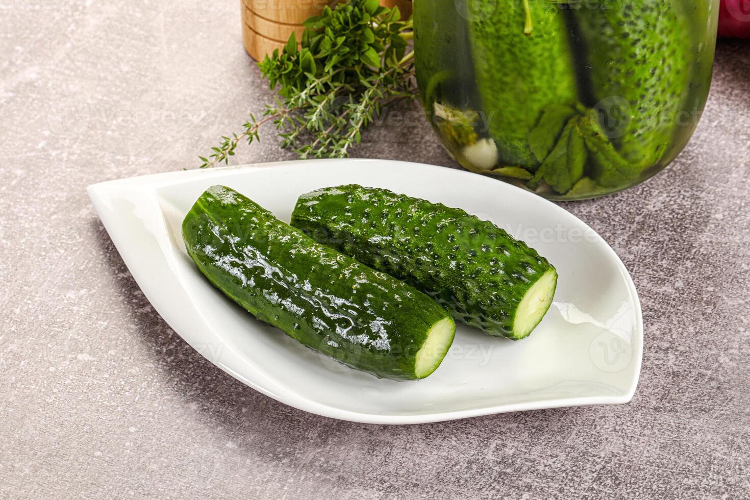 Homemade lighty salted cucumbers with herbs photo