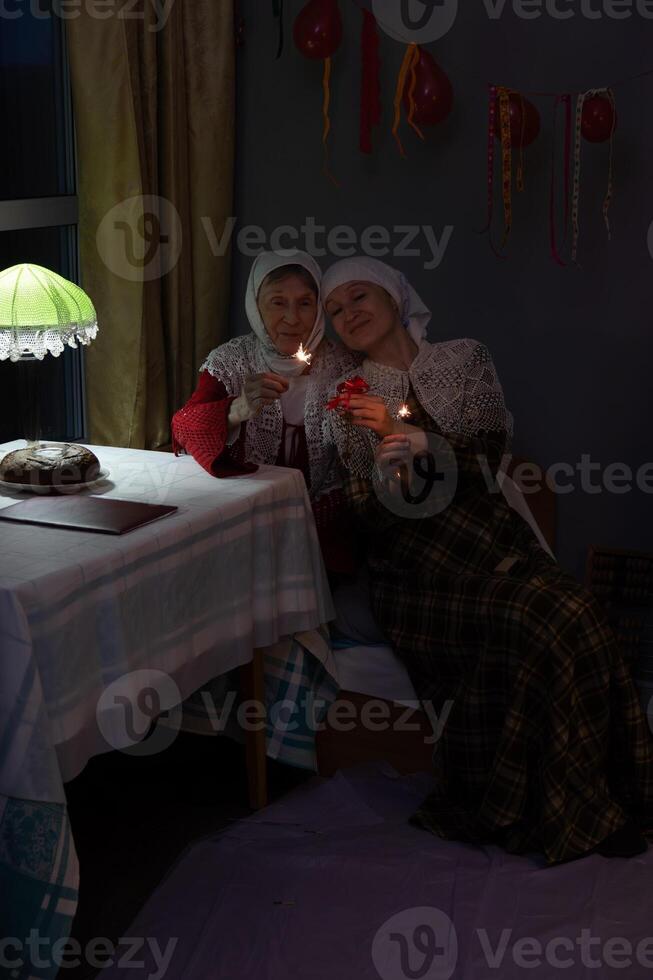 Two women sitting on a bed photo