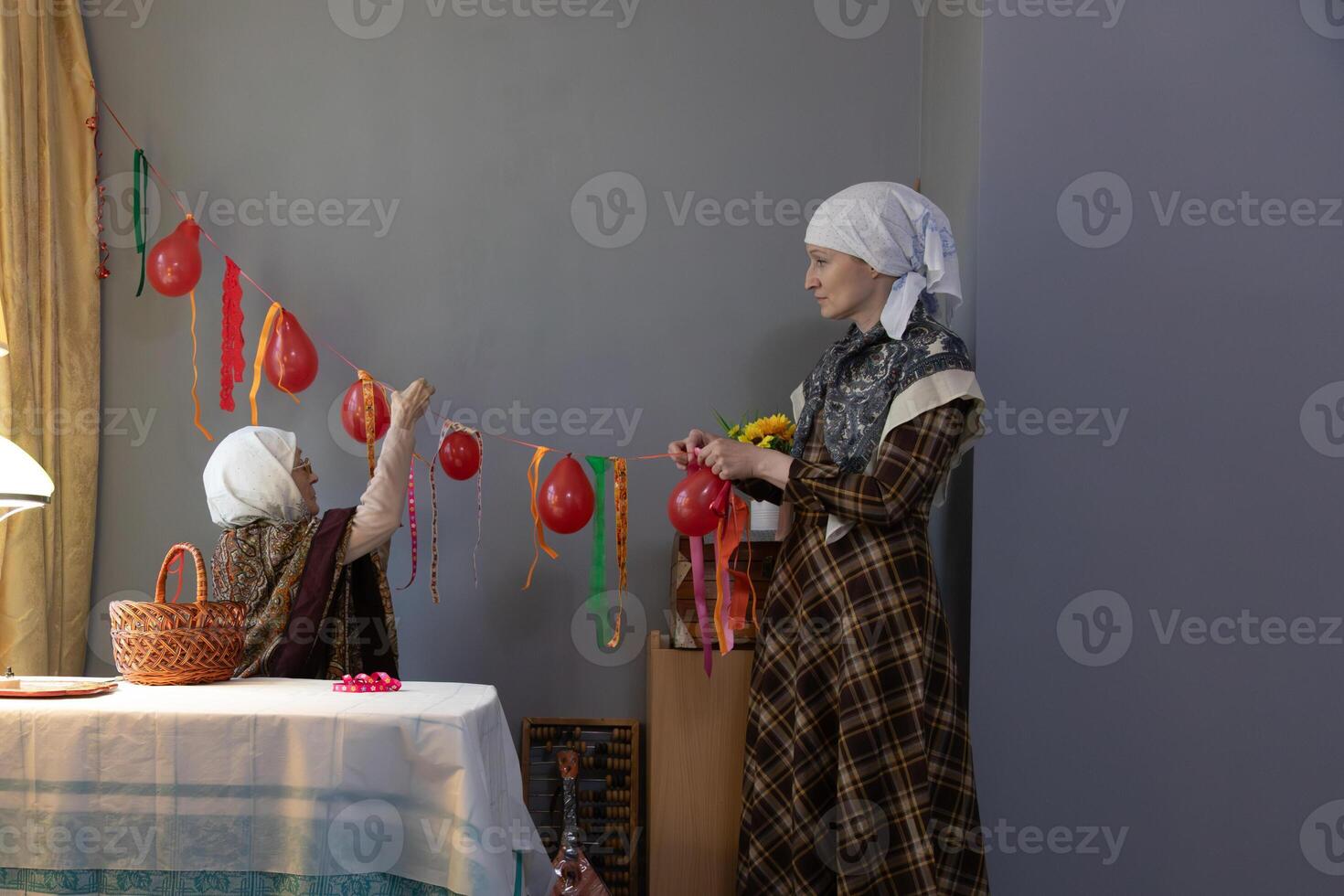 A woman and a child are decorating a table with balloons photo
