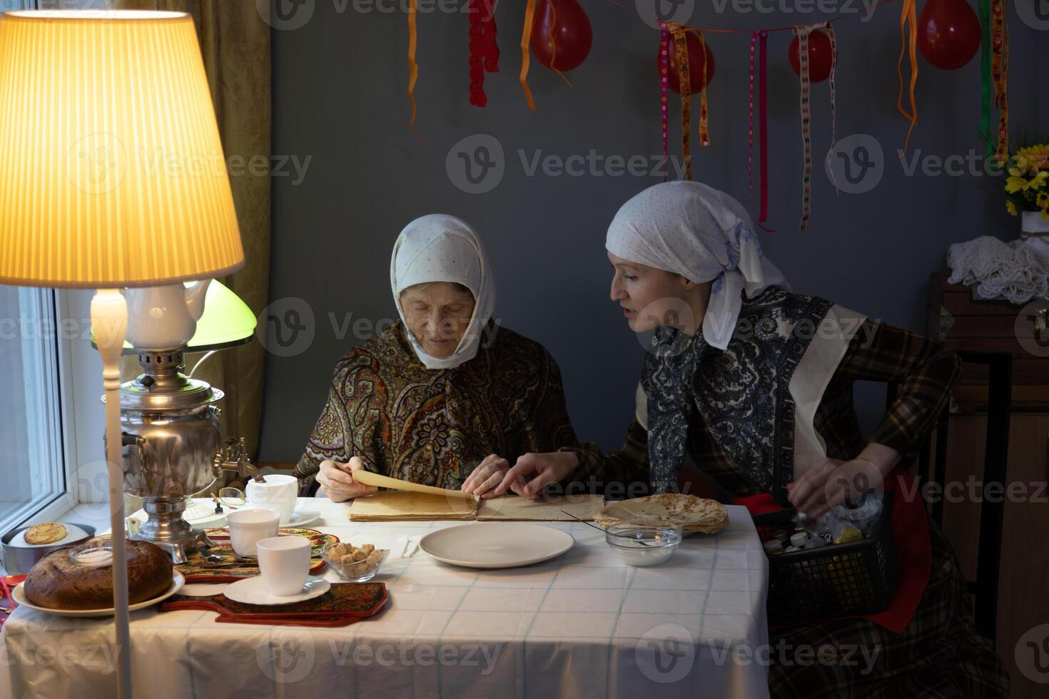 Two women sitting at a table photo