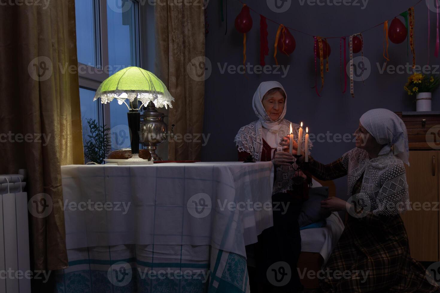 Two women sitting on a table photo