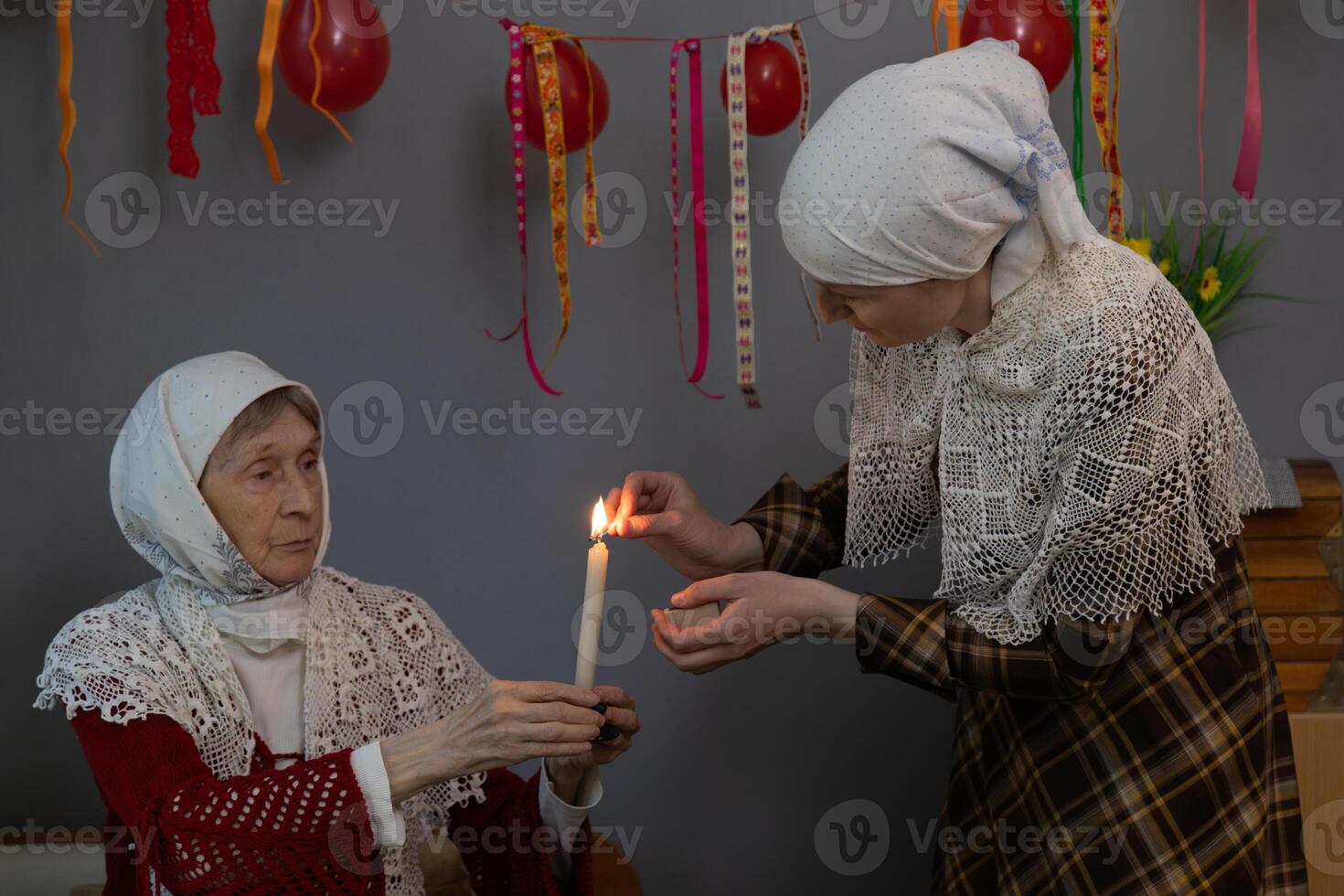 A woman holding a lit candle photo
