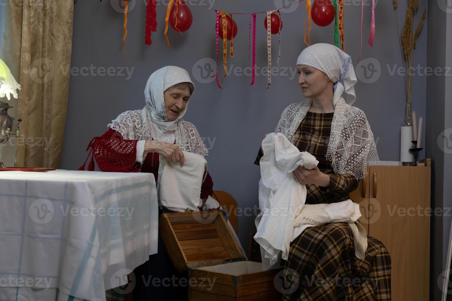 Two women sitting on a table photo