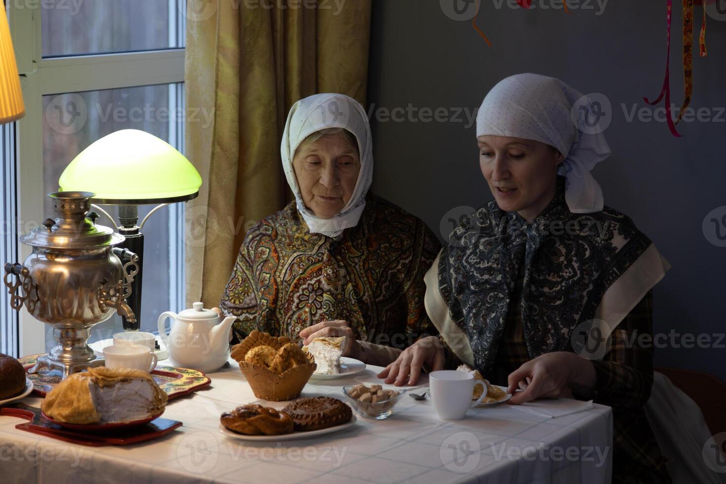 Two women sitting at a table photo