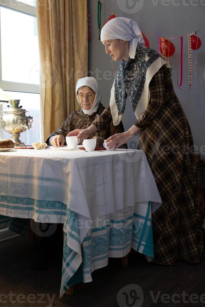 Two women standing at a table photo