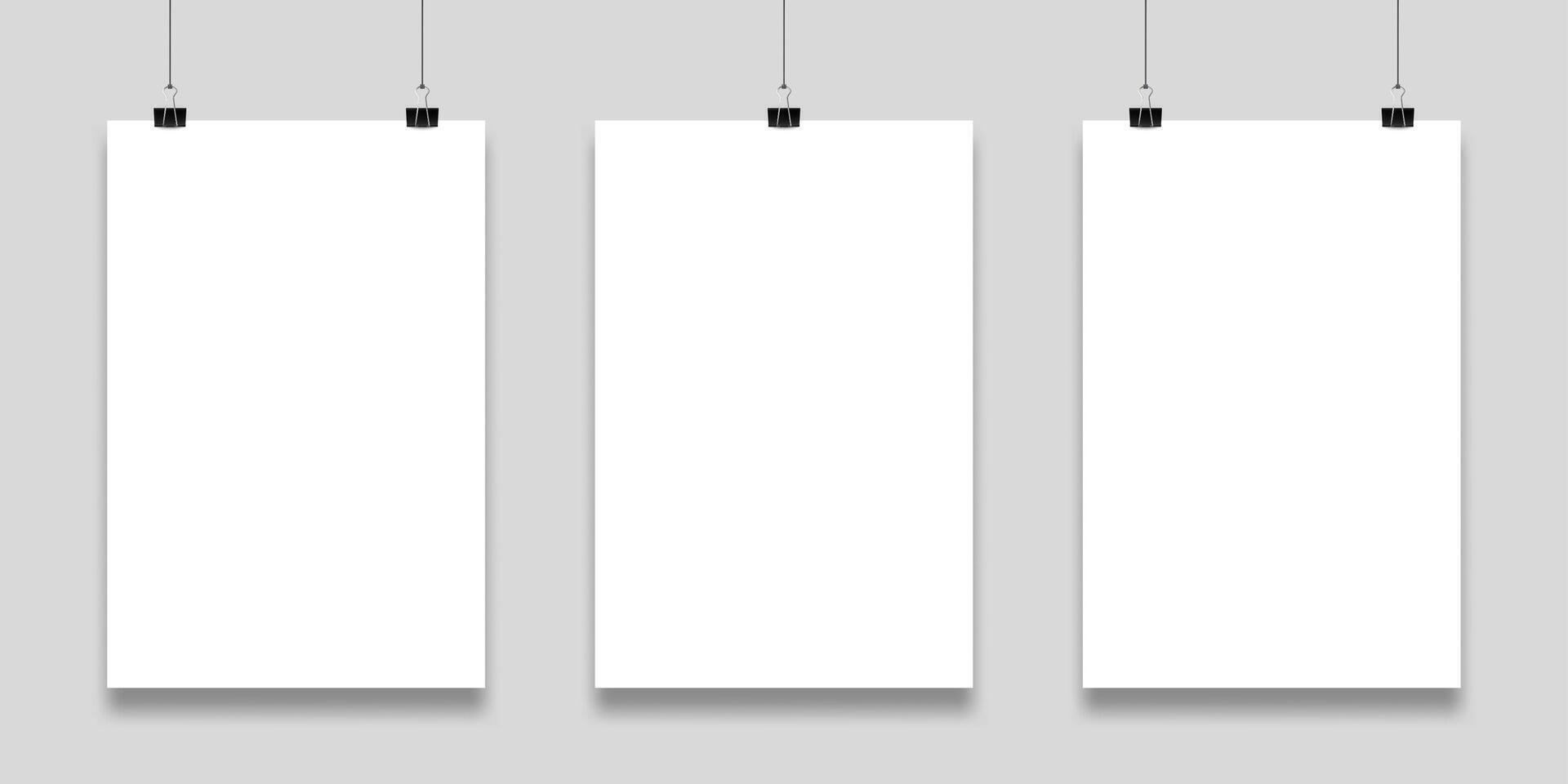Three blank white papers are hanging on a gray wall, held by black binder clips, providing a clean and professional backdrop for displaying artwork or announcements vector