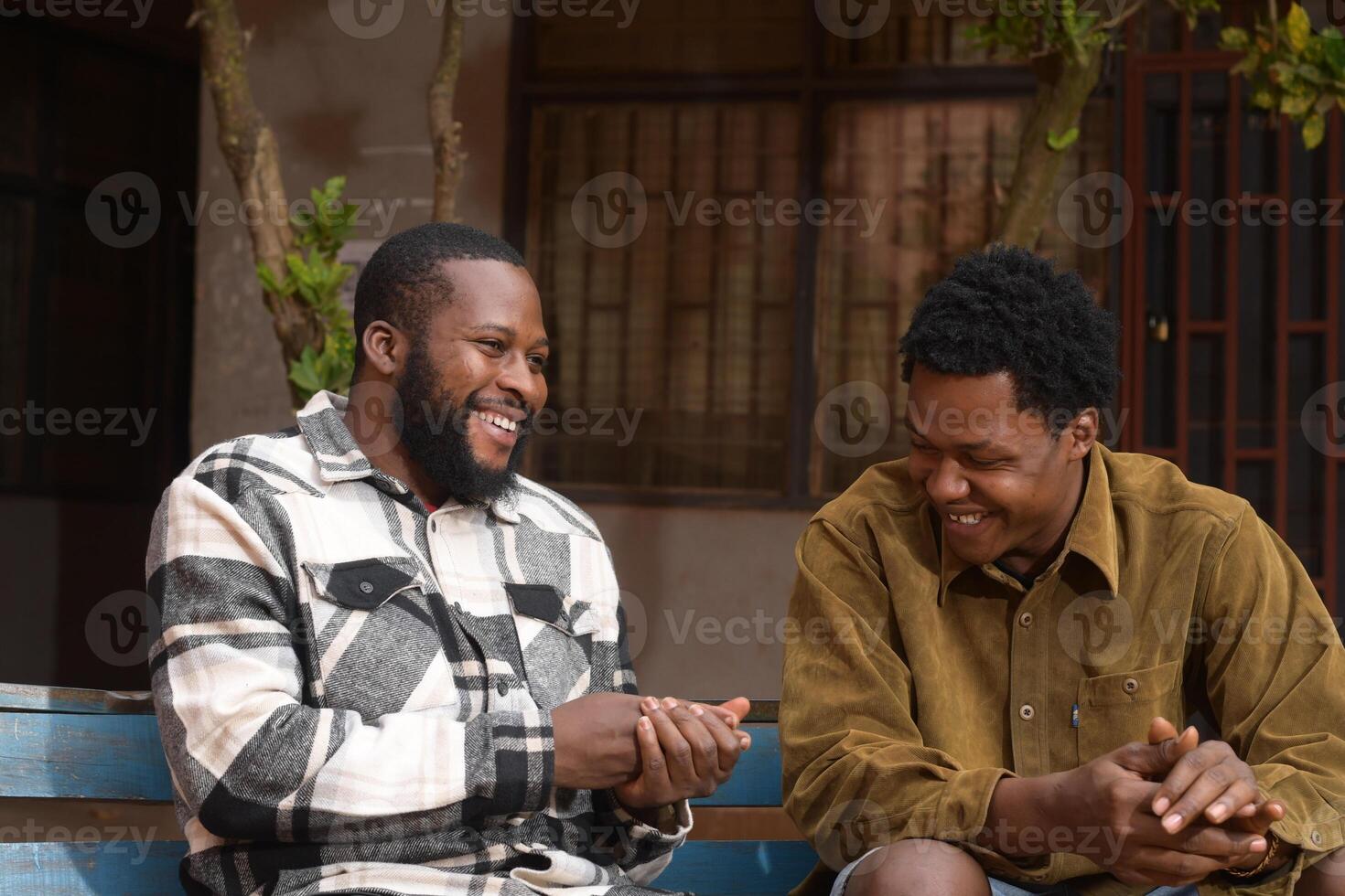 two handsome african feeling excited about what they saw on their cellphone photo