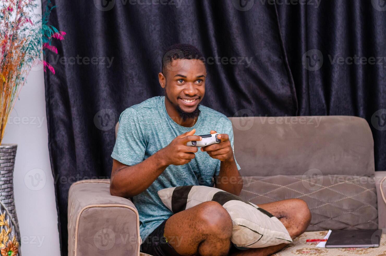 Close up of attractive hipster with bristle and toothy grin, holding joy stick and playing videogames on tv at vacation photo
