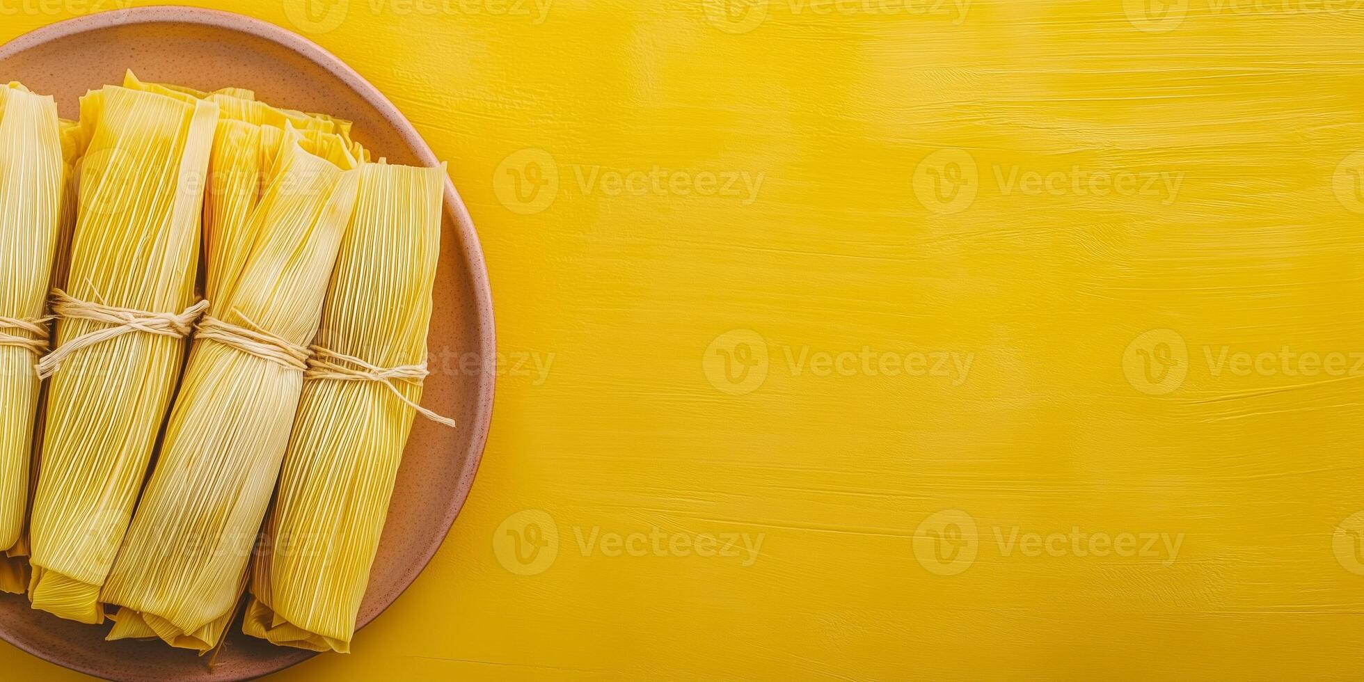 Top-down view of tamales with corn husks wrapped around the filling, neatly arranged on a dish, food setting photo