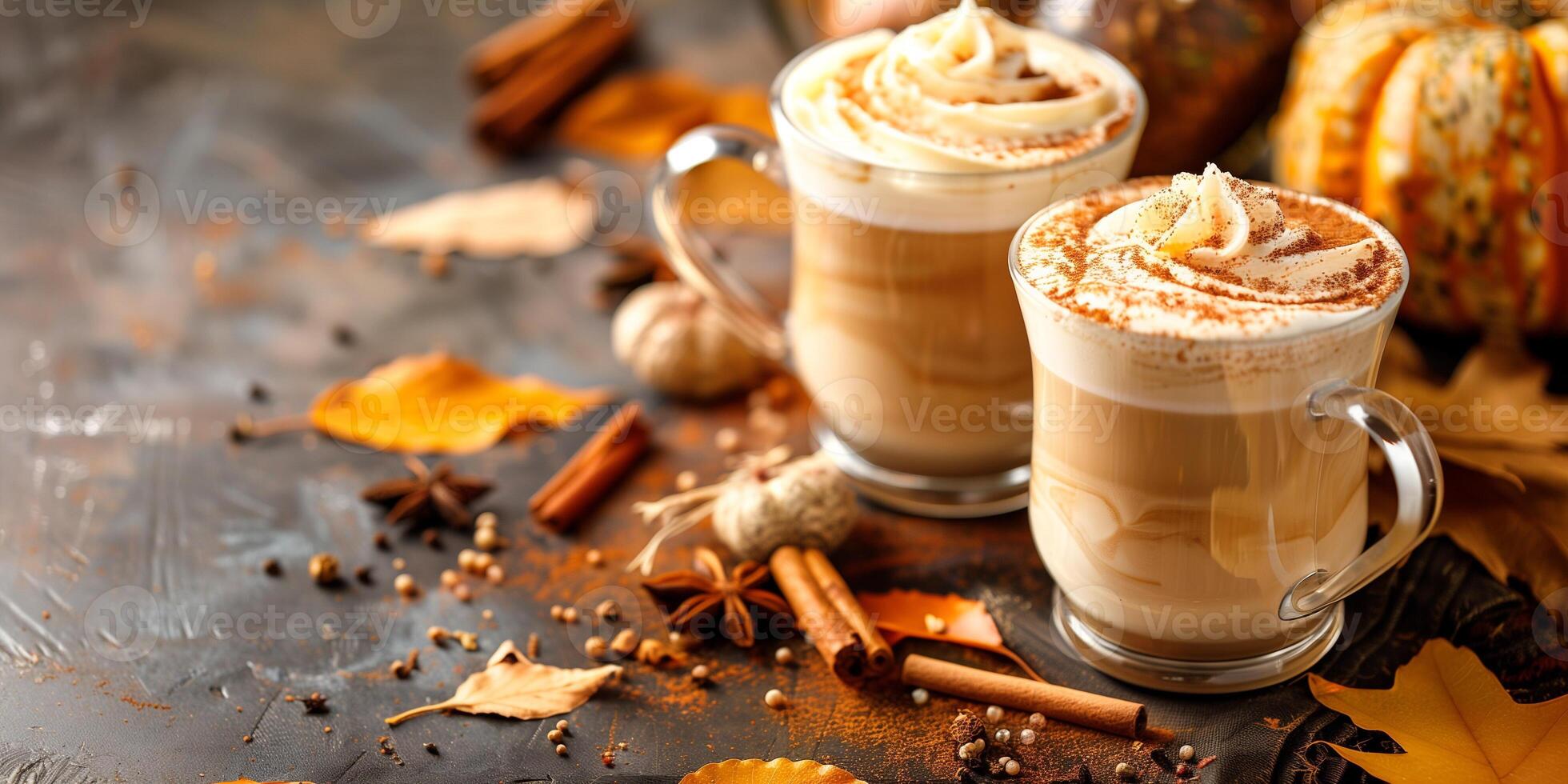 Pumpkin spice lattes in glass cups on a table, surrounded by autumn leaves and whole spices, food setting photo