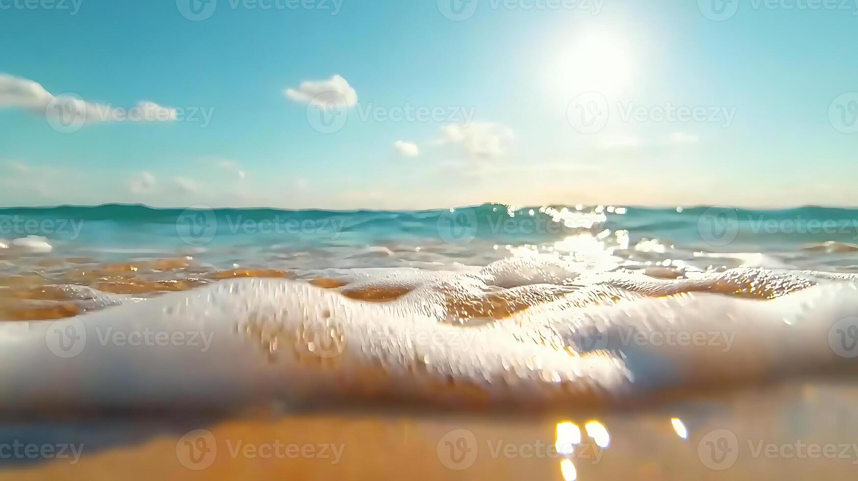 serene beach view with gentle waves lapping at shore under bright sun. clear blue sky and sparkling water create tranquil atmosphere photo