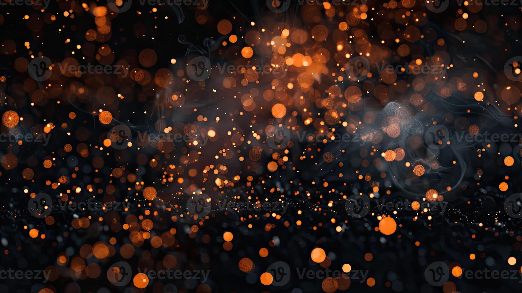 Orange sparkles on black background photo