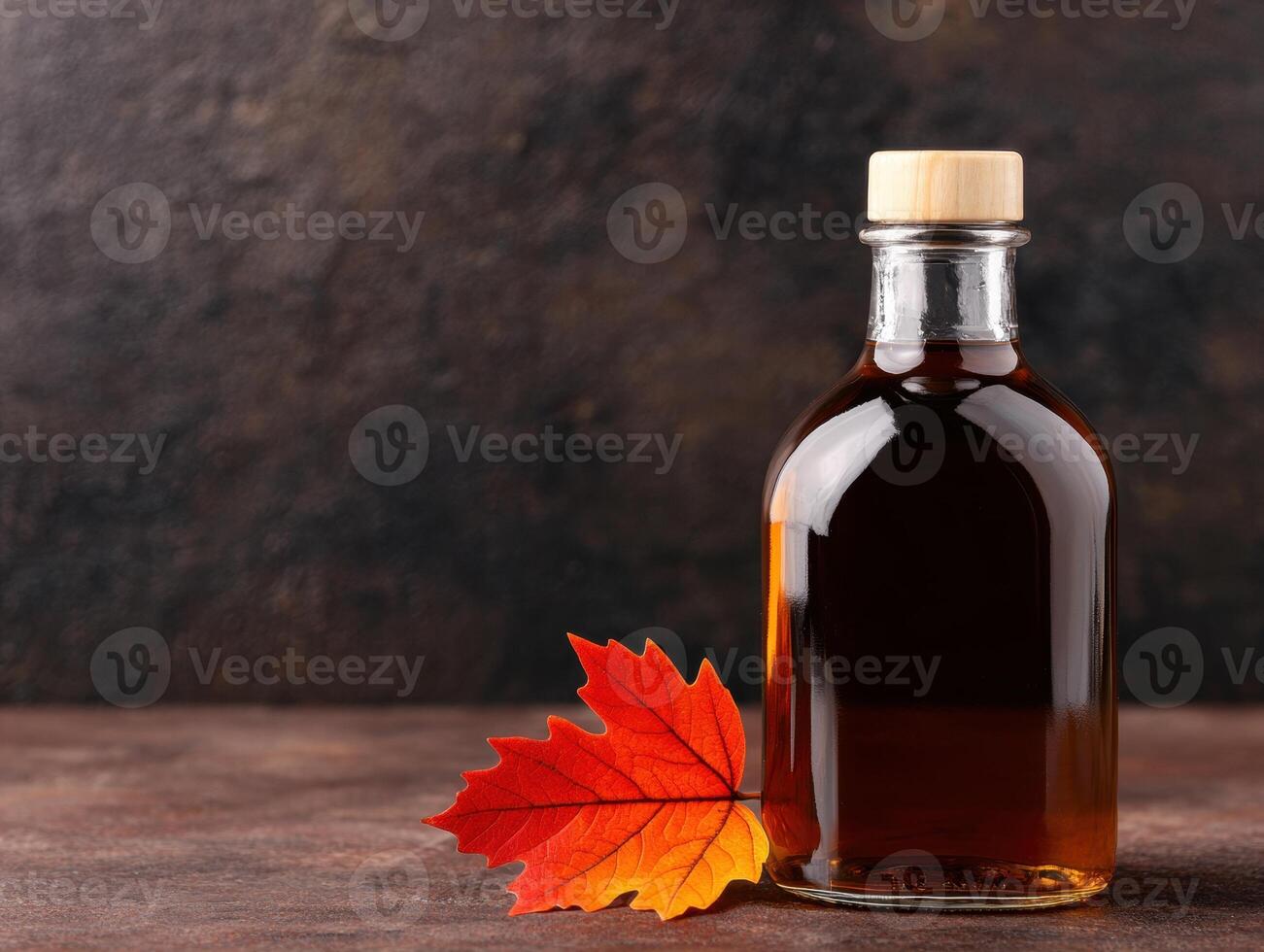 Autumn maple leaf and maple syrup bottle photo