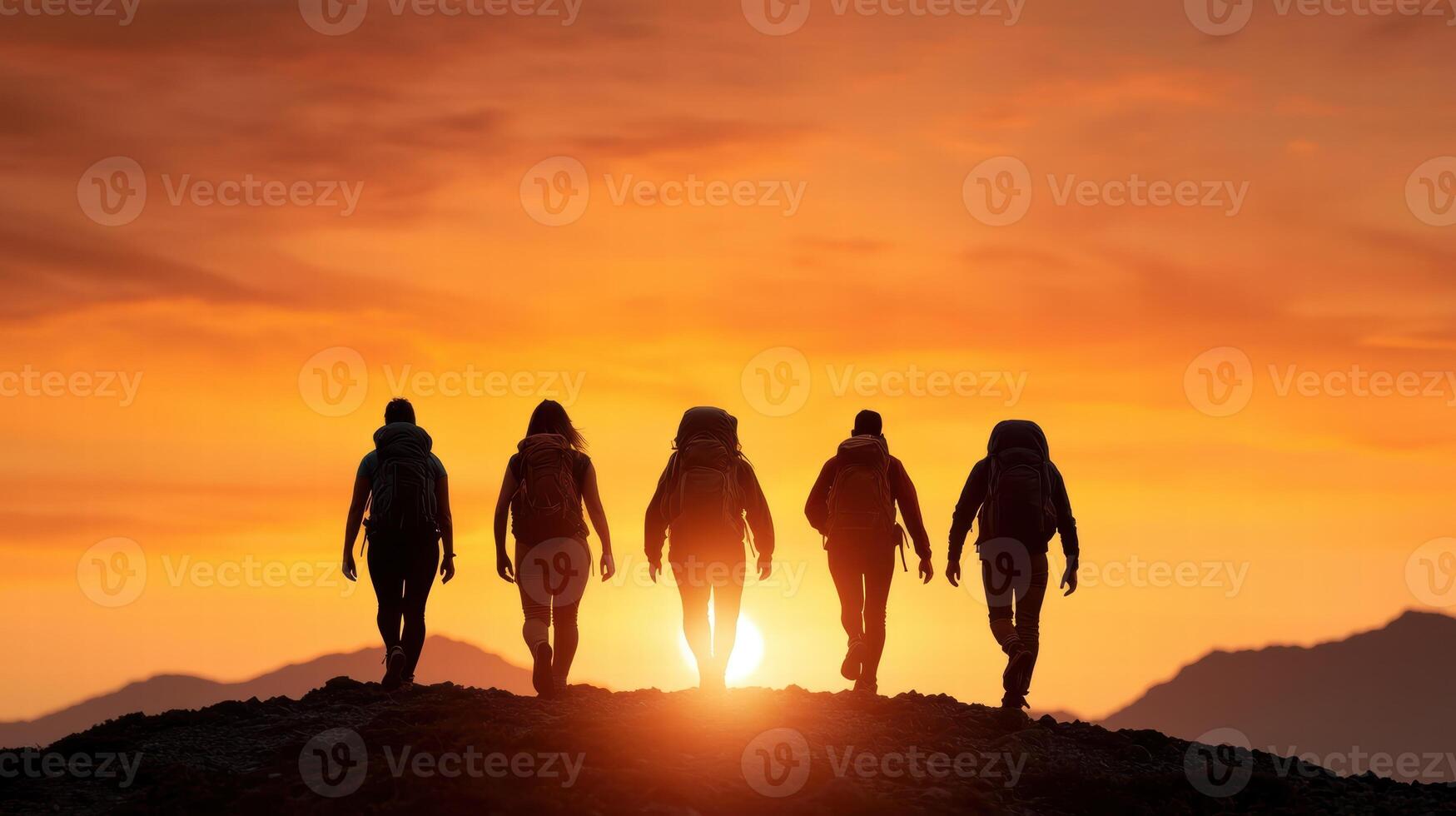 silhouettes of people walking towards the sunset photo
