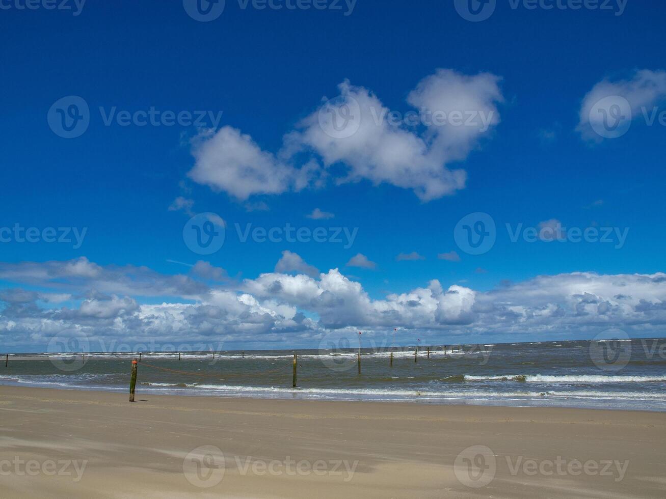 A blue sky with white clouds at norderney beach photo