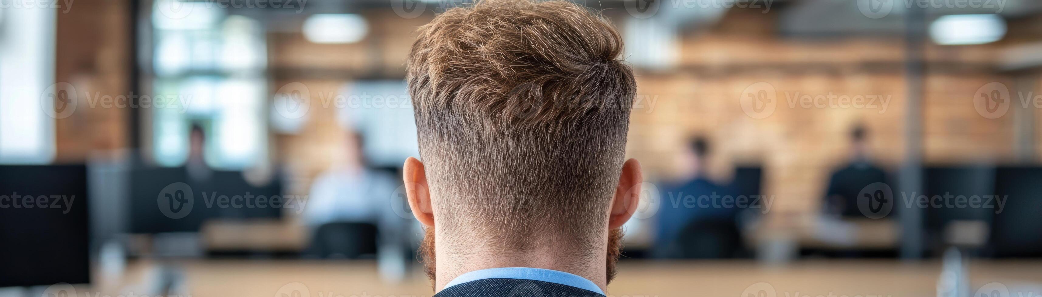 man with short brown hair in modern office photo