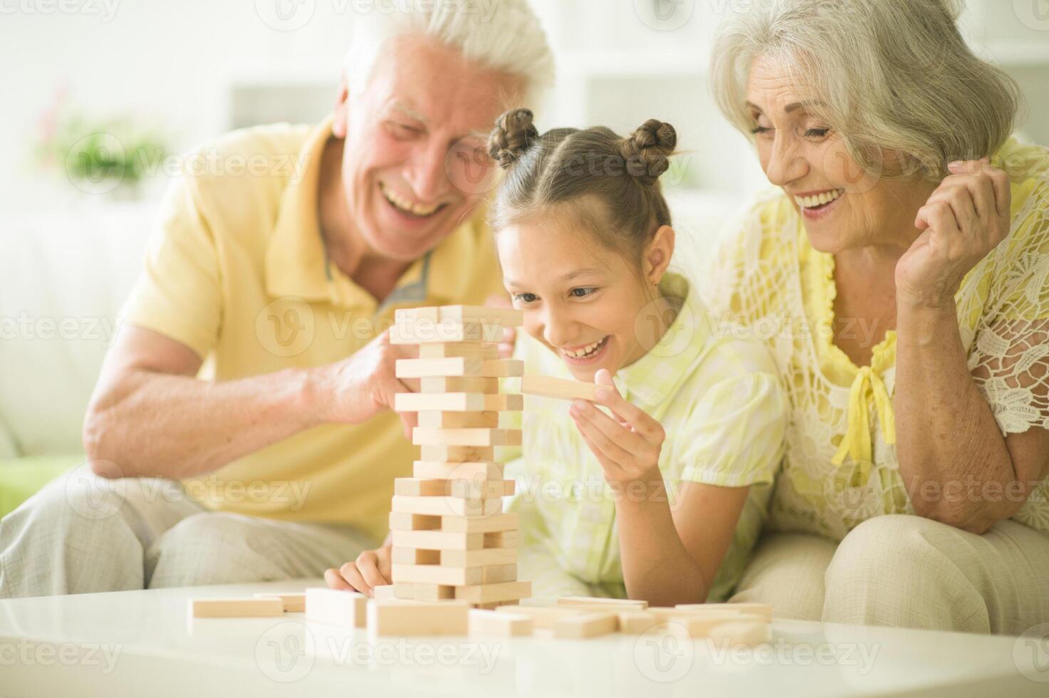 Close up portrait of happy family playing with wooden blocks photo