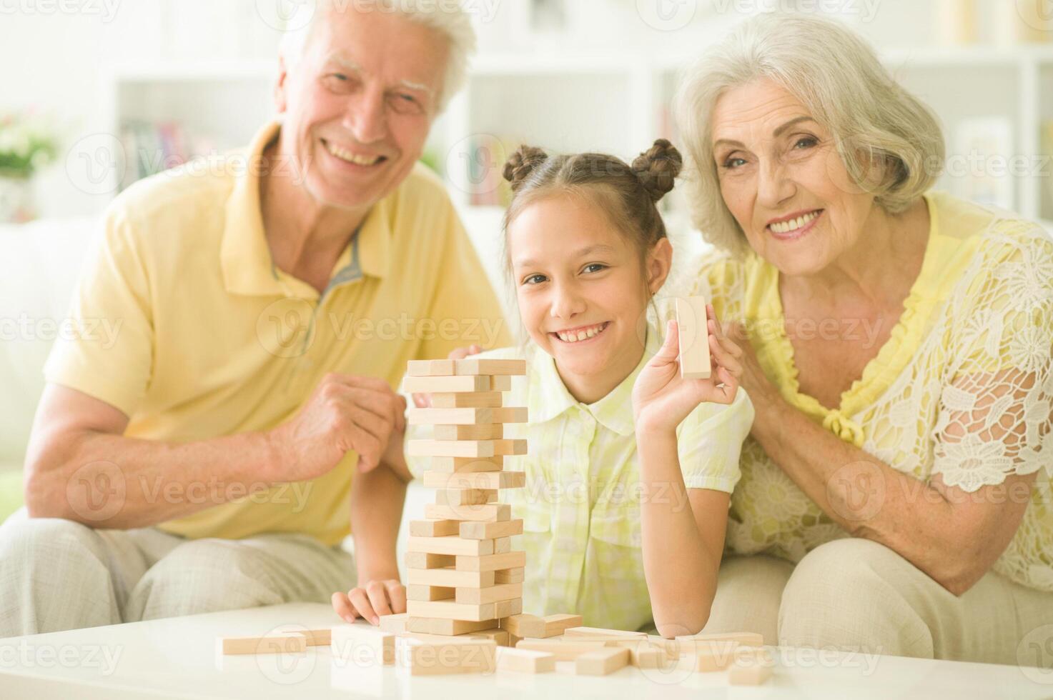 Close up portrait of happy family playing with wooden blocks photo