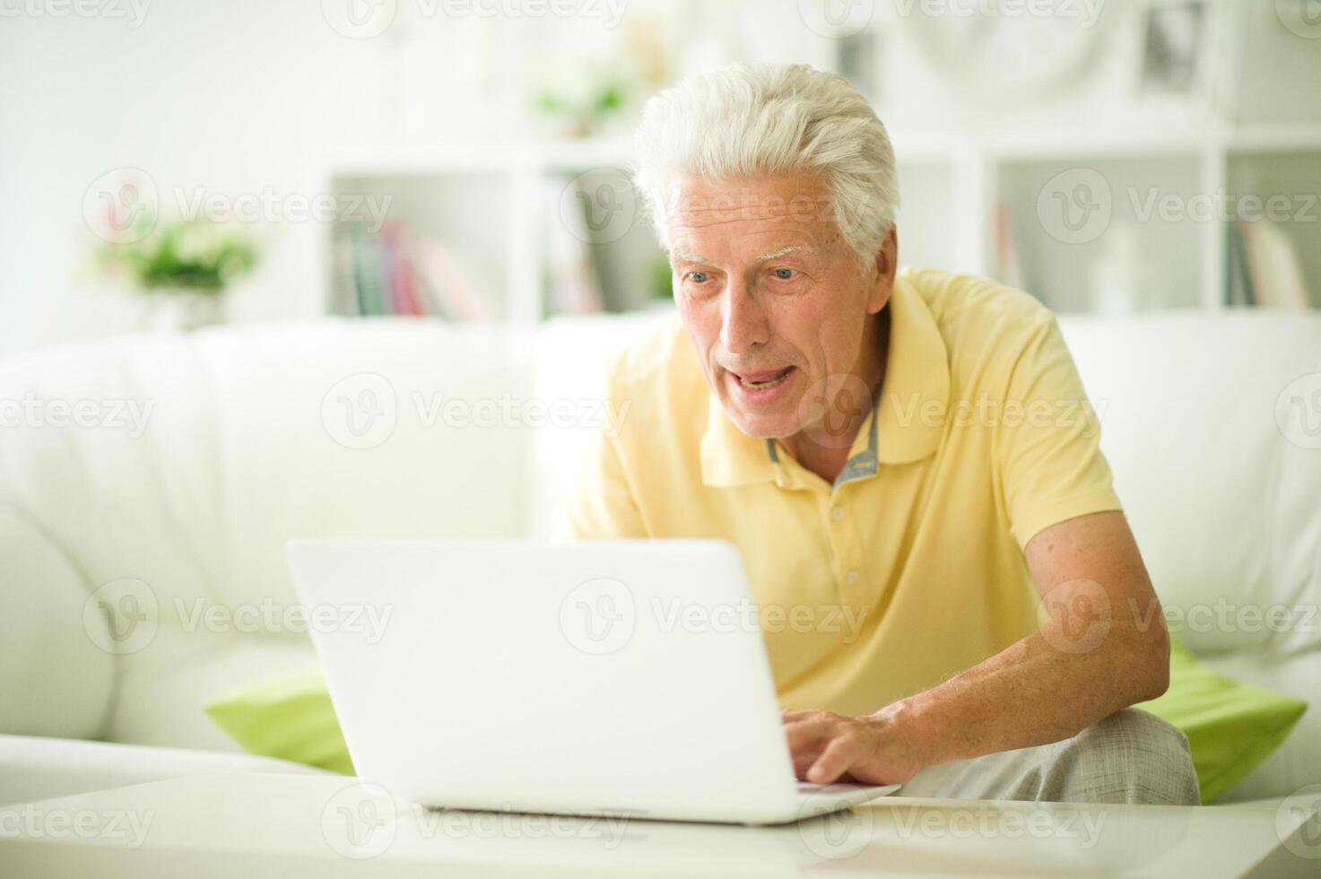 Portrait of thoughtful senior man with laptop photo