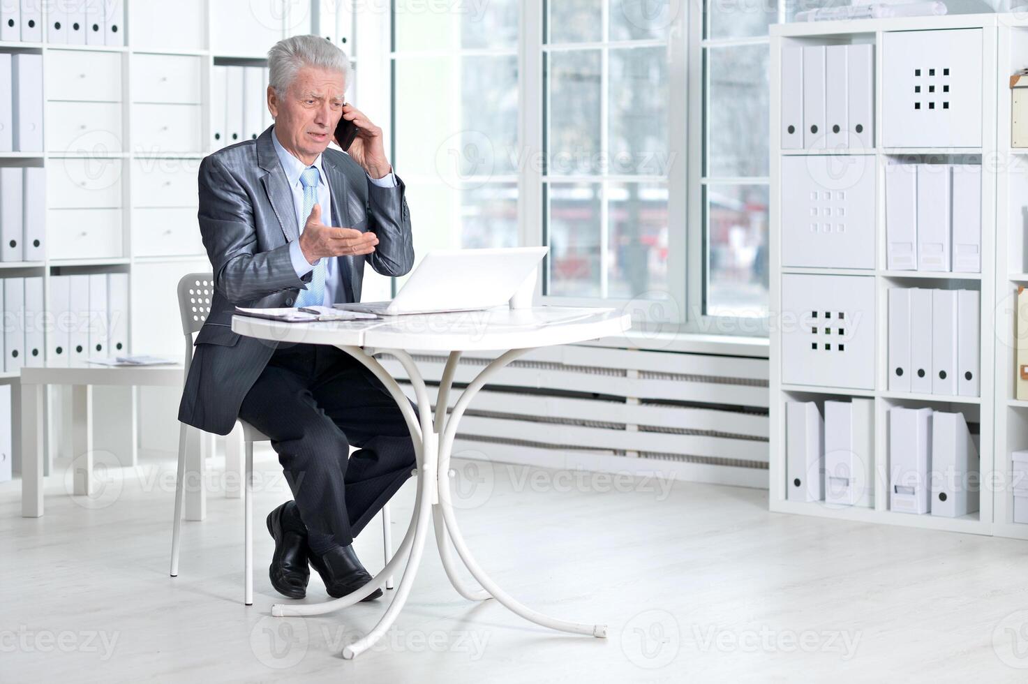 Senior businessman working with computer in office photo