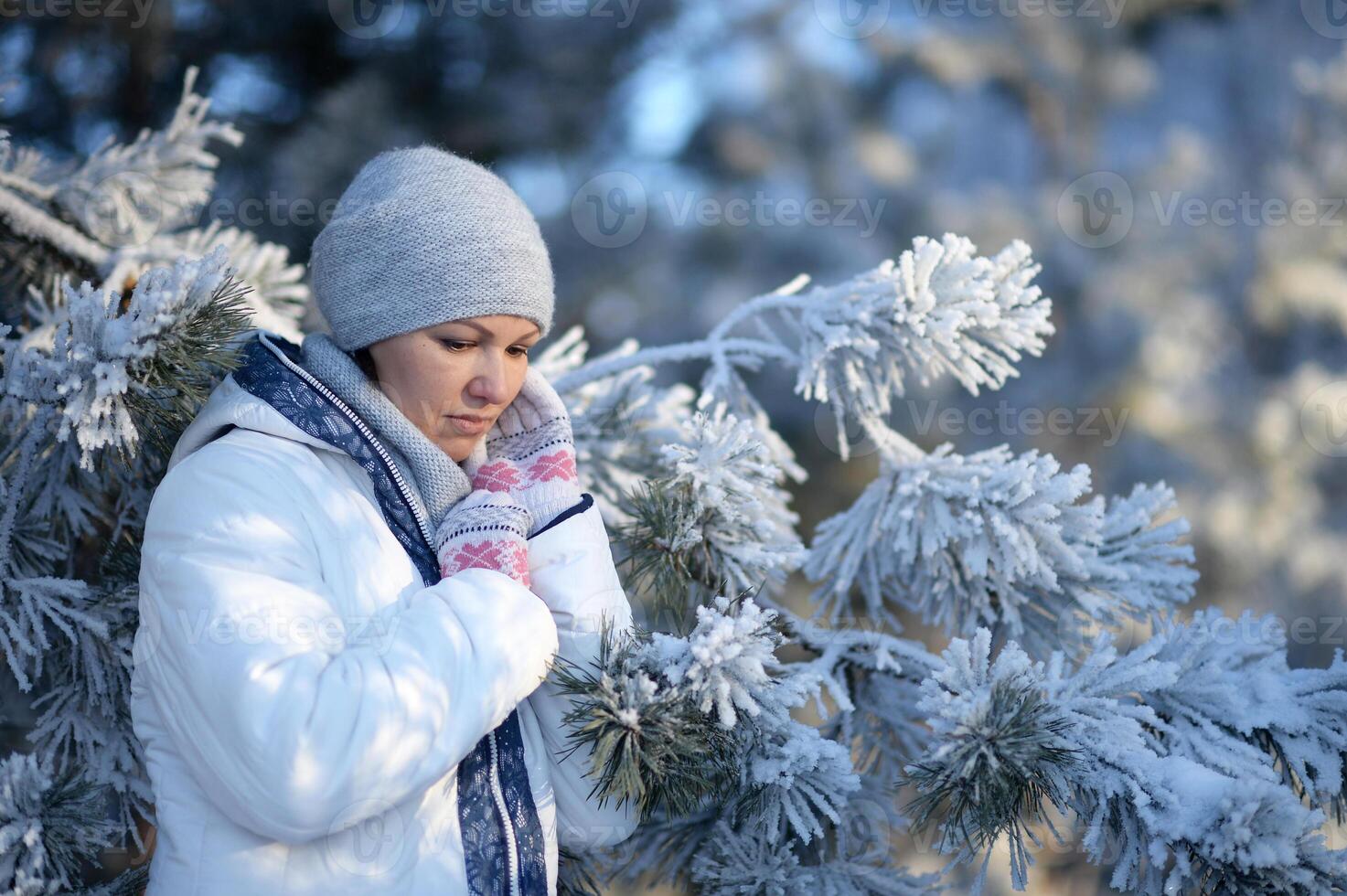 Portrait of beautiful woman posing in park photo
