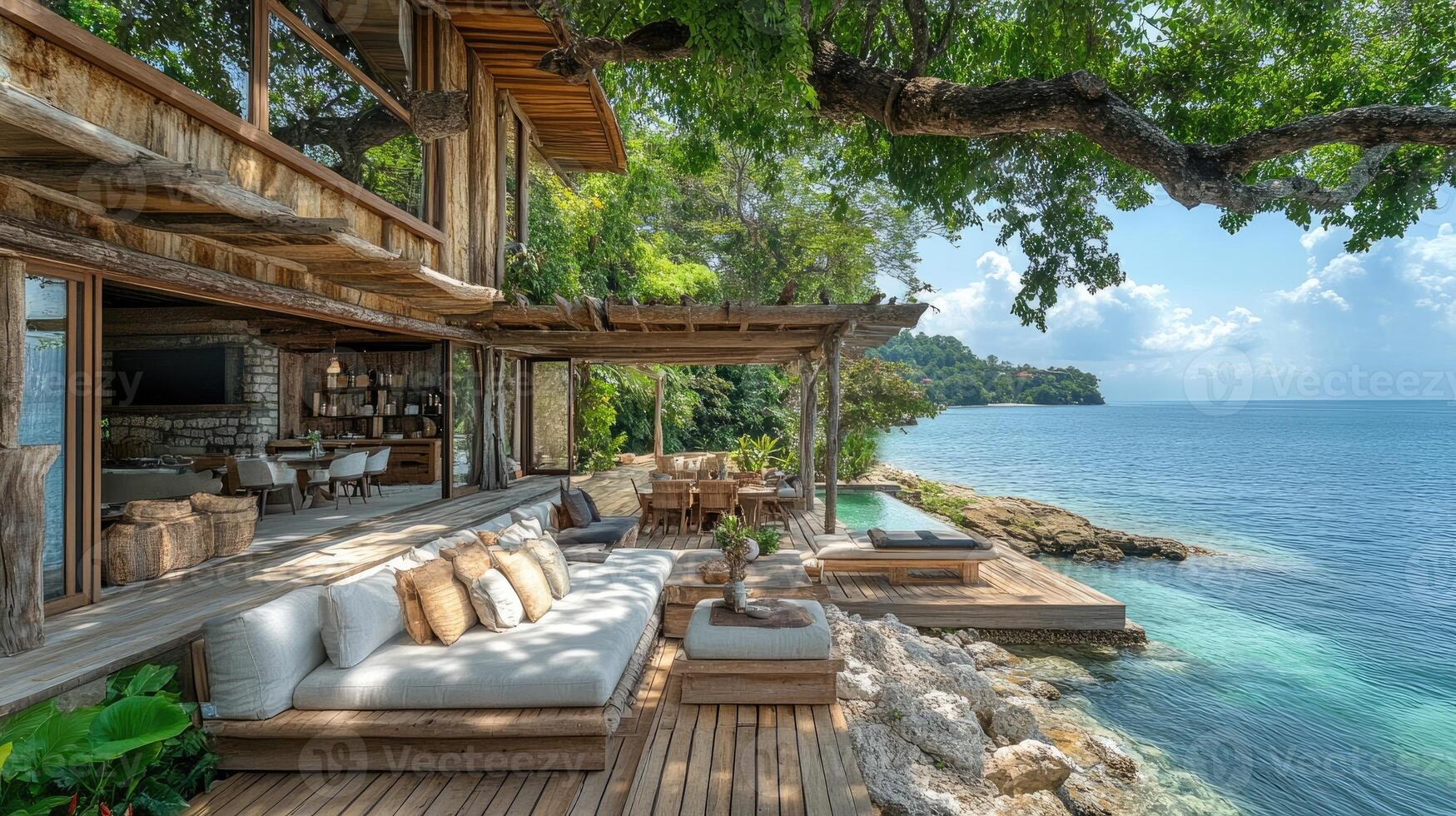 Luxurious beachfront villa with infinity pool overlooking tropical ocean photo