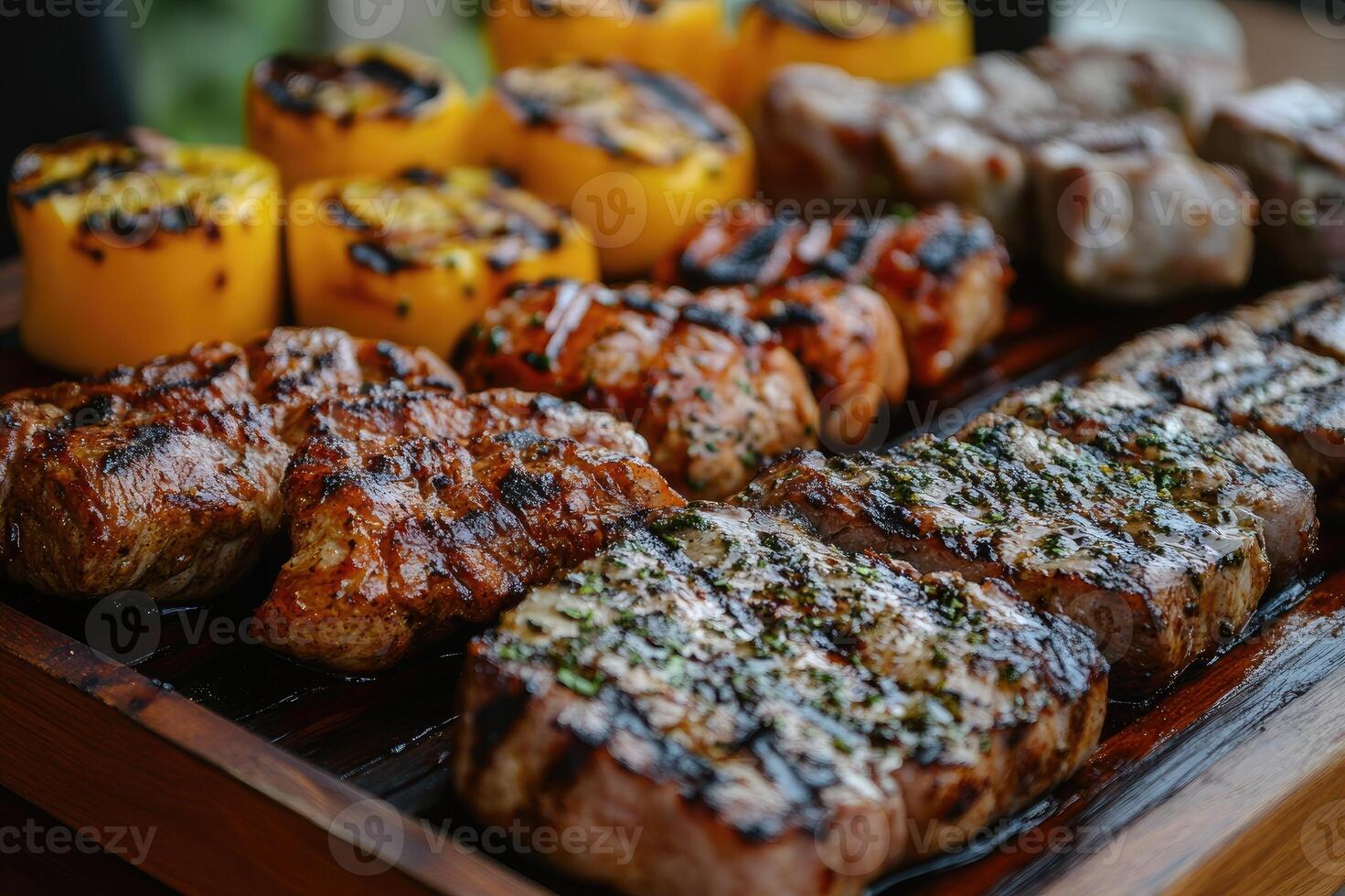 Delicious grilled meat and vegetables displayed on wooden tray photo