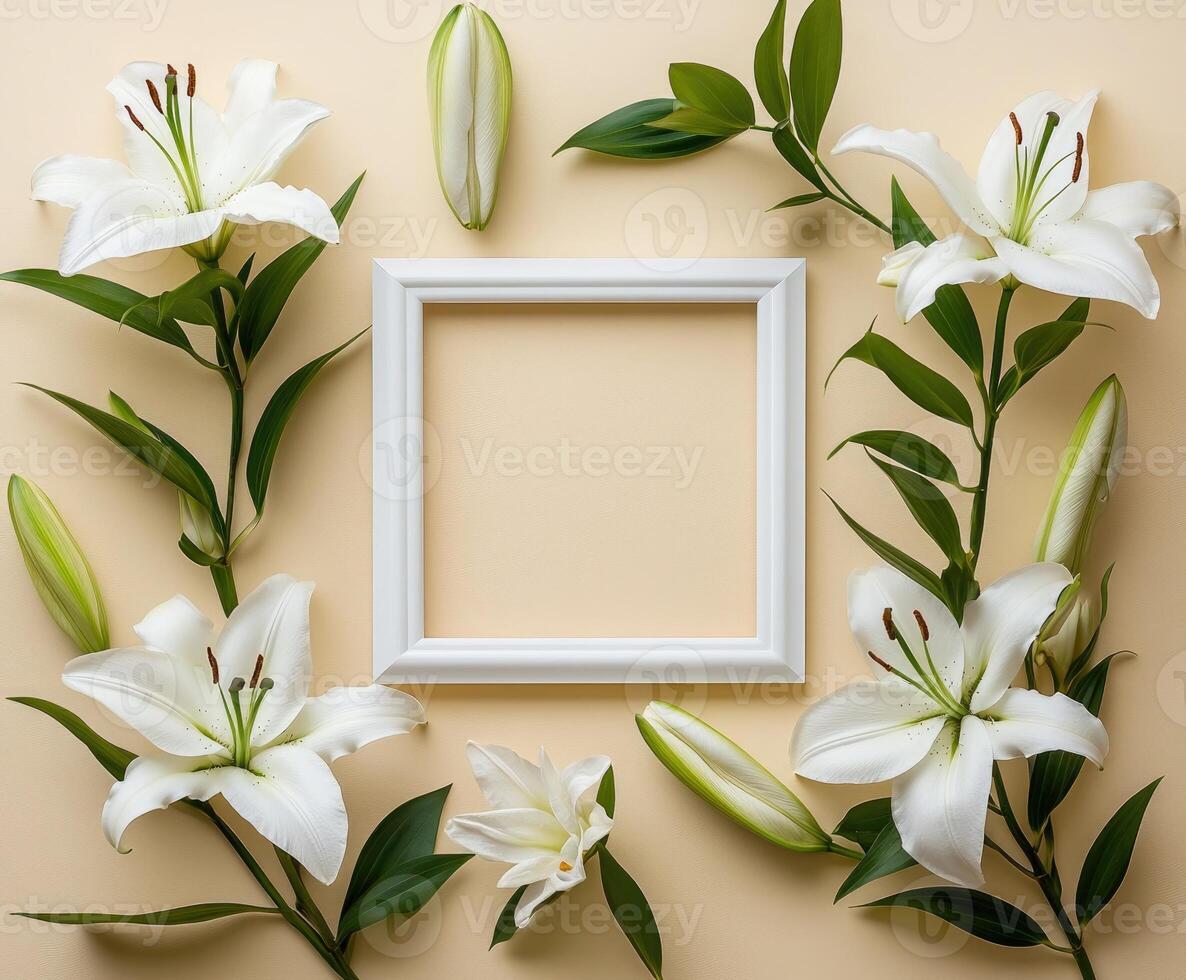 White lilies surrounding empty frame on beige background photo