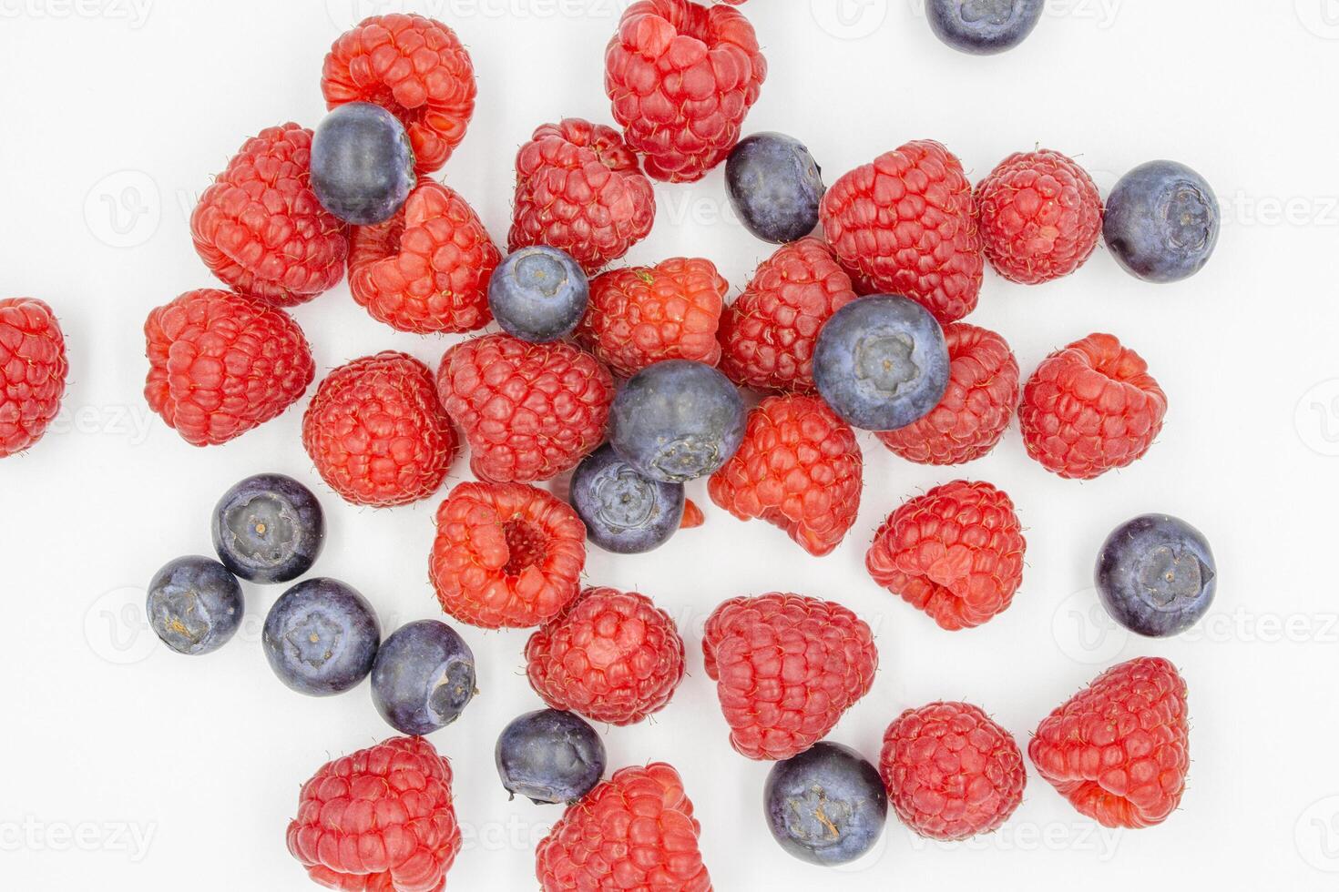 fresh forest blueberry and raspberry isolated on white background, top view. Fresh ripe berry on a white background. photo