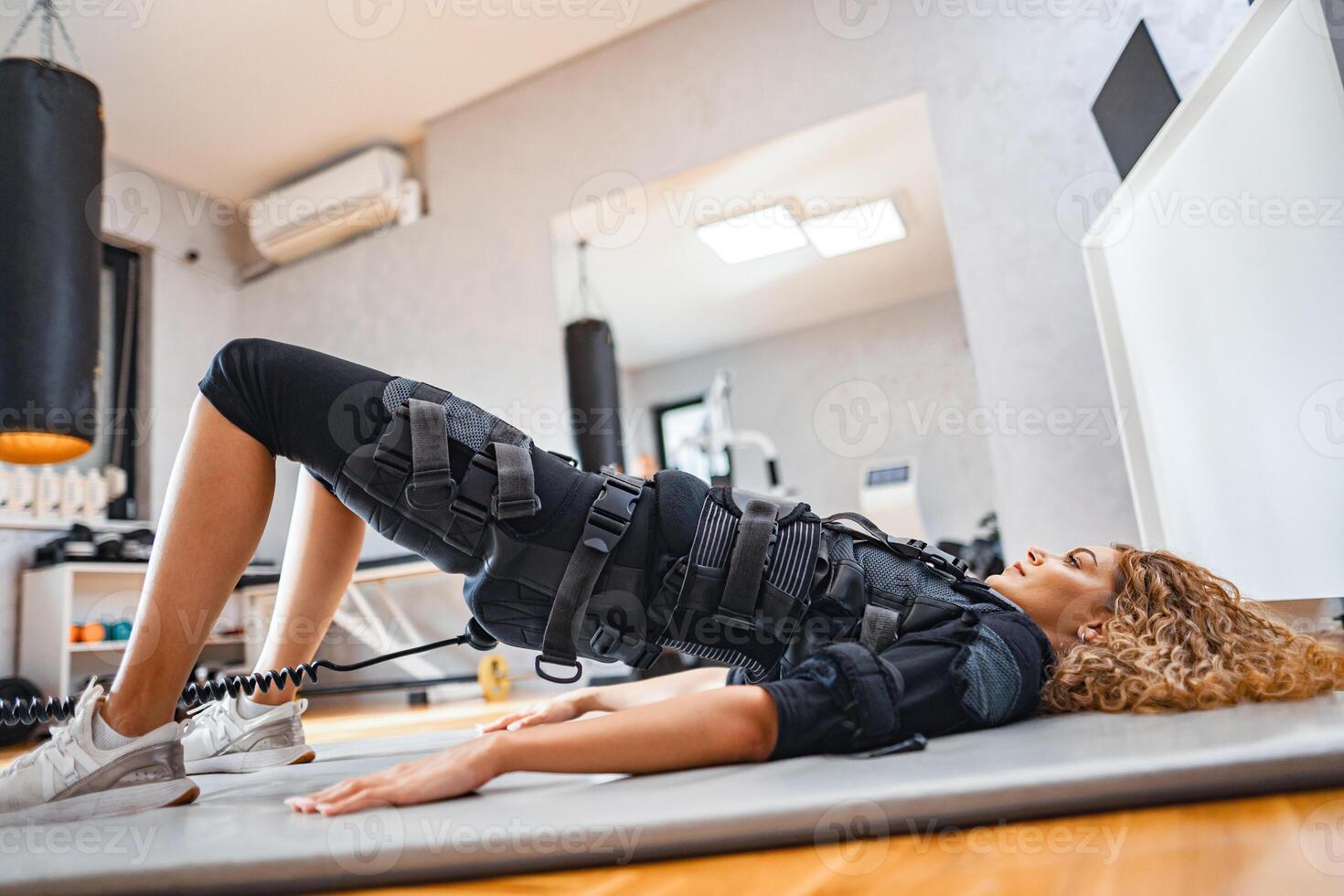 Body sculpting with electronic muscle stimulation photo